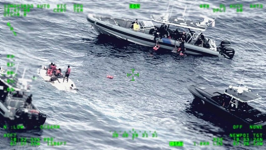 People stand on a capsized boat, left, as some passengers are pulled up on to a rescue boat, top, in the open waters northwest of Puerto Rico, Thursday, May 12, 2022. Some people have been rescued while others were found dead after the boat carrying suspected migrants capsized. (Seventh U.S. Coast Guard District via AP)