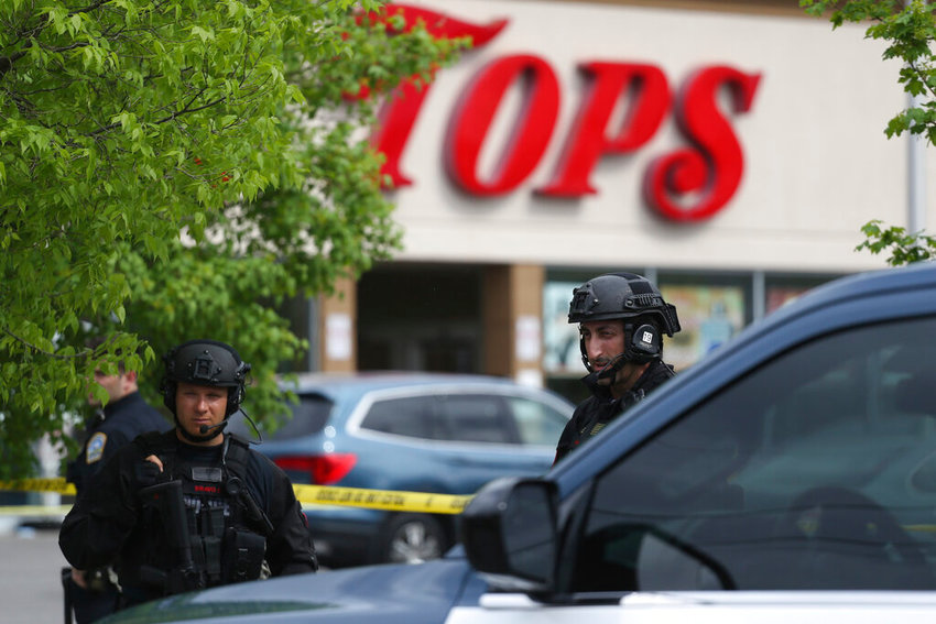 Police secure a perimeter after a shooting at a supermarket, Saturday, May 14, 2022, in Buffalo, N.Y. (AP Photo/Joshua Bessex)